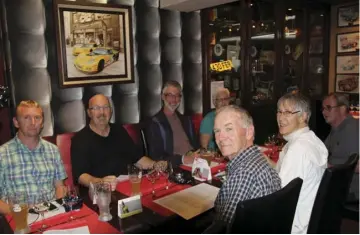  ??  ?? James, Terry, Barney and Jeanette in the back row, Roger, Katharine and Paul in front, contemplat­ing the menu at the Le Mans Legends café