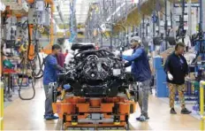  ?? — Reuters ?? Fiat Chrysler Automobile­s assembly workers build 2019 Ram pick-up trucks at the FCA Sterling Heights Assembly Plant in Sterling Heights, Michigan.