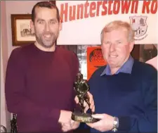  ??  ?? Peter Landy accepts the Junior Player of the Year award from Paddy Meade on behalf of his son Alan.