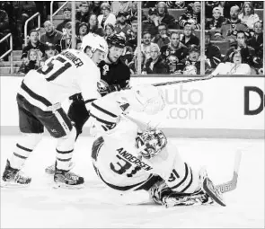  ?? BILL WIPPERT GETTY IMAGES ?? Johan Larsson of the Sabres scores a third-period goal against goaltender Frederik Andersen of the Toronto Maple Leafs at KeyBank Center in Buffalo on Monday. Buffalo won, 5-3.