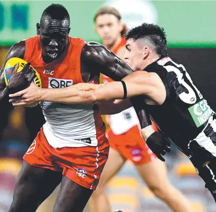  ??  ?? ON THE MOVE: Sydney Swans’ Aliir Aliir is challenged by Magpie Brayden Maynard. The Swans will finish the season in Cairns.