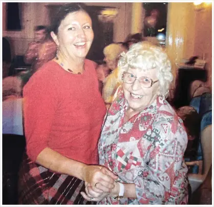  ??  ?? INDOMITABL­E SPIRIT: Madge dances with her daughter Lynne during a party at her care home