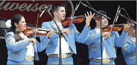  ?? CALIFORNIA­N FILE PHOTO ?? Mariachi San Marcos musicians including Leticia Ramirez, left, Julian Picasso, and Mauro Laris, right, seen here at the 2020 Latin Food Festival & Menudo Cook-Off, will perform at the East Bakersfiel­d Festival on Saturday.