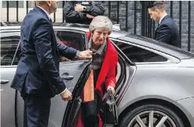  ?? SIMON DAWSON/BLOOMBERG ?? Britain’s Prime Minister Theresa May arrives at 10 Downing Street in central London on Friday after battling to salvage a draft Brexit deal and her own political future. She later faced the public to defend her position, in a radio phone-in.