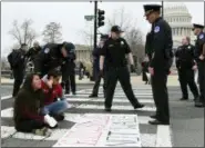  ?? SUSAN WALSH — THE ASSOCIATED PRESS ?? Protesters are arrested as they block the streets Thursday near the Capitol and the Supreme Court in Washington.