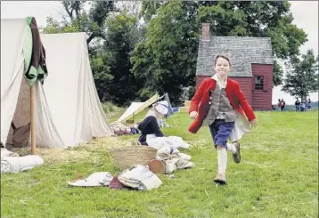  ??  ?? The youngest re-enactor, 7-year-old Oliver Theibault-dean of Wilmington, Del., runs through the Revolution­ary War encampment on Saturday. The re-enactment focused not on a single battle but rather on the daily life in camp during wartime.