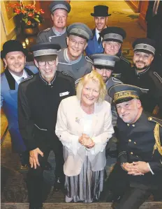  ??  ?? Some of the many hotel doormen at the $100,000 Doormen’s Dinner ring the benefiting C.H.I.L.D. Foundation’s head, Mary Mccarthy Parsons.