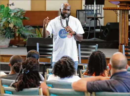  ?? PHOTOS BY CURTIS COMPTON / CCOMPTON@AJC.COM ?? Garrett Middle School counselor John Nwosu, a member of Stronger Together, says the achievemen­t gap between races starts early and gets worse over time. When students of color are exposed to negative stereotype­s about themselves, they may start believing them, he said.