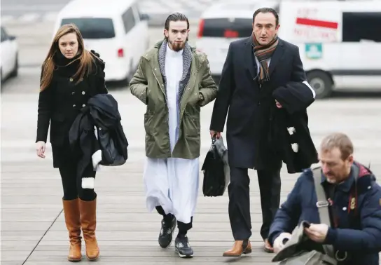  ??  ?? A suspected member of a radical group arrives at a court in Antwerp, Belgium, in this file photo. (Reuters)