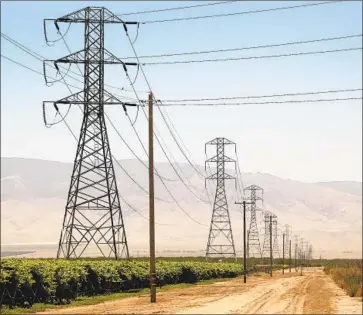  ?? Al Seib Los Angeles Times ?? POWER LINES run through orchards in Kern County. The state wants 100% clean energy by 2045. President Biden’s goal is 2035. California already has plenty of clean power and often shares it with other Western states.