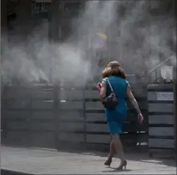  ?? MATT YORK, THE ASSOCIATED PRESS ?? Water misted on to sidewalks in Tempe, Ariz., Monday where it was 118 F (47.7 C).