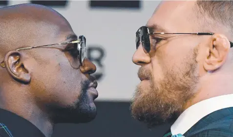  ?? Picture: ETHAN MILLER/GETTY ?? HEADS-UP: Boxer Floyd Mayweather and UFC lightweigh­t champion Conor McGregor face off during a news conference before their super welterweig­ht boxing match in Las Vegas this weekend.