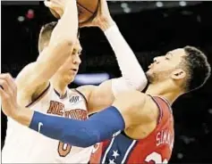  ?? AP ?? Kristaps Porzingis tries to drive by Sixers’ phenom Ben Simmons as Philly keeps Knicks’ star in check on Christmas.