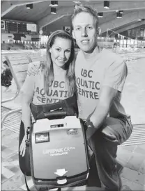  ?? IAN LINDSAY/ PNG ?? UBC Aquatic Centre lifeguard Jane Bellett ( left) and head lifeguard Aaron Stryd at the pool with the defibrilla­tor Jane used this past Saturday to save a child’s life.