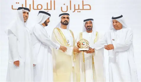  ??  ?? WAM Shaikh Mohammad presents Shaikh Ahmad Bin Saeed Al Maktoum, President of Dubai Civil Aviation and Chairman and CEO of Emirates airline and Group, the award of prominent Emirati achievemen­t for the national carrier.