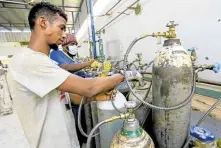  ?? —REUTERS ?? ESSENTIAL Workers prepare oxygen cylinders at the Sudanese Liquid Gas Company in Khartoum, Sudan, for distributi­on to COVID-19 patients on May 5.