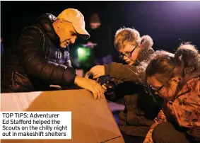  ??  ?? TOP TIPS: Adventurer Ed Stafford helped the Scouts on the chilly night out in makeshift shelters