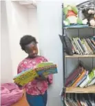  ?? Helen H. Richardson, The Denver Post ?? Jackie, 10, reads a book during summer day camp at the Village Exchange Center, a nonprofit that offers day camps for children with internatio­nal background­s.