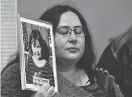  ?? FRANK GUNN / THE CANADIAN PRESS ?? Jennifer Neville-lake holds a photo of her late daughter Milly following Marco Muzzo’s parole hearing in Gravenhurs­t, Ont., on Wednesday.