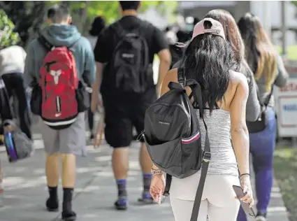  ?? Associated Press file photo ?? Students head to class at Miami Dade College. Most state-sponsored 529 plans, which help pay for college, have improved significan­tly in recent years, experts say.