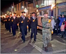  ??  ?? A torchlight procession, led by Lewis Pipe Band, left from Stornoway Town Hall to the Sports Centre ahead of A Community Remembers.