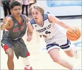  ?? Scott Herpst ?? Gordon Lee senior guard Weston Beagles drives past a Mt. Zion defender on his way to the basket last week. Beagles had a career-high 32 points, but the Trojans would come up two points short in a heartbreak­ing 77-75 loss to the Eagles.