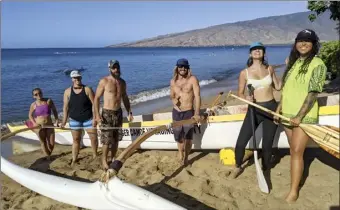  ?? ?? Hawaiian Paddle Sports employees Rachel Holden (from right), Chelsea Pickles, Greg Masessa, Matt Barnes and Jen Schuler and Becky Egli of Kraken Coffee prepare to launch a canoe for the Paddle for Hunger course at Kihei Canoe Club on Thursday morning. “We’re earning our dinner,” Barnes said.