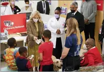  ?? PATRICK SEMANSKY — THE ASSOCIATED PRESS ?? First lady Jill Biden hands out stickers to recently vaccinated children during a visit to a pediatric COVID-19 vaccinatio­n clinic at Children’s National Hospital’s THEARC, Wednesday, Nov. 17, 2021, in Washington.