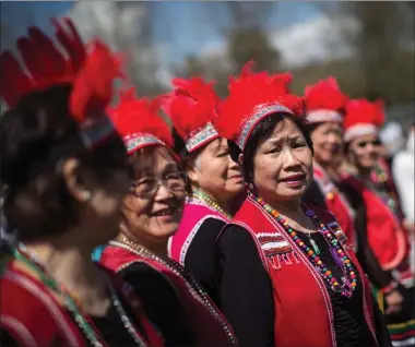  ?? The Canadian Press ?? A group of women wait to perform as part of a Chinatown Culture Day event after Vancouver Mayor Gregor Robertson delivered an apology on behalf of the city for past discrimina­tion against residents of Chinese descent, during a special city council...