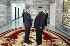  ?? SOUTH KOREA PRESIDENTI­AL BLUE HOUSE — YONHAP VIA AP ?? In this photo provided by South Korea Presidenti­al Blue House via Yonhap News Agency, North Korean leader Kim Jong Un, right, and South Korean President Moon Jae-in, left, shake hands before their meeting at the northern side of the border in...