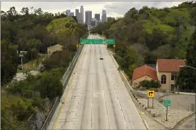  ?? MARK J. TERRILL — THE ASSOCIATED PRESS FILE ?? In this March 20, file photo, extremely light traffic moves along the 110Harbor Freeway toward downtown during mid-afternoon in Los Angeles.