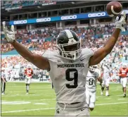  ?? DOUG MURRAY — THE ASSOCIATED PRESS ?? Michigan State running back Kenneth Walker III celebrates scoring a touchdown in Saturday’s win over Miami. He leads the nation in rushing, averaging 164 yards per game.