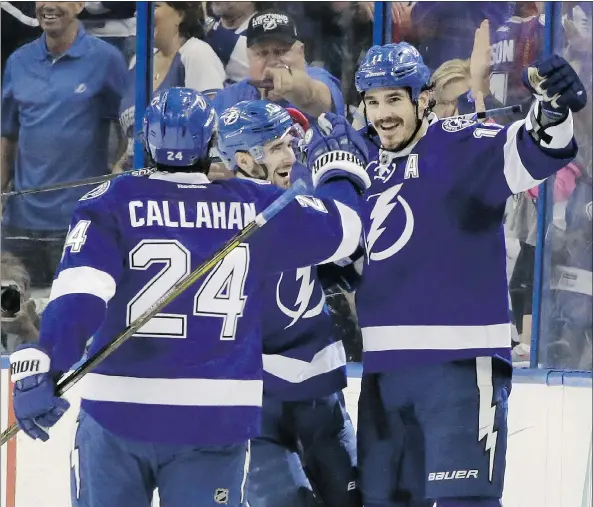  ?? — AP ?? Tampa Bay Lightning forward Ryan Callahan, left, congratula­tes teammate Brian Boyle, right, after Boyle scored in Game 5 of their Eastern Conference second-round series with the New York Islanders in Tampa, Fla. The Lightning won 4-0 to advance to the...