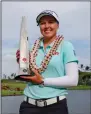  ?? JAMM AQUINO/THE STARADVERT­ISER VIA AP ?? Brooke Henderson, of Canada, holds the trophy after winning the LPGA Lotte Championsh­ip golf tournament Saturday in Kapolei, Hawaii.