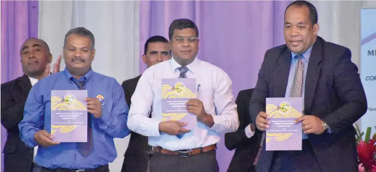  ?? Photo: Shahani Mala ?? Minister for Education, Heritage and Arts Mahendra Reddy (middle), holds up a copy of the School Managers Handbook at the Xavier College in Ba on April 18, 2017.