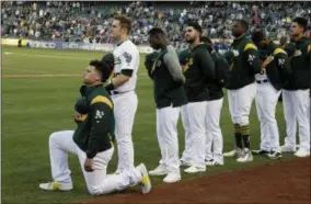  ?? ERIC RISBERG — THE ASSOCIATED PRESS ?? Oakland Athletics catcher Bruce Maxwell kneels during the national anthem before the start of a baseball game against the Texas Rangers Saturday, Sept. 23, 2017 in Oakland Bruce Maxwell of the Oakland Athletics has become the first major league...