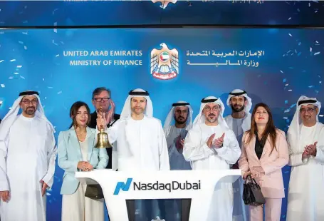  ?? Ministry of Finance ?? Mohamed Al Hussaini, Minister of State for Financial Affairs, rings Nasdaq Dubai’s bell to celebrate listing of the first dirhamdeno­minated T-bond as heads of agent banks and the stock market officials look on