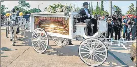  ??  ?? The casket of Floyd is carried by a horse-drawn carriage to his final resting place in Houston, Texas.