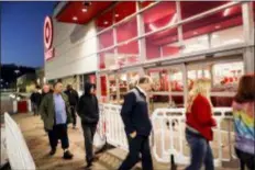  ?? JOHN MINCHILLO — THE ASSOCIATED PRESS ?? Shoppers wait in queue outside for Black Friday sales at a Target store, Friday in Newport, Ky.