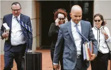  ?? Chip Somodevill­a / Getty Images ?? Kathleen Manafort, second from left, wife of former Trump campaign chairman Paul Manafort, leaves the Alexandria, Va., courthouse Wednesday with lawyer Brian Ketcham, left, on day two of Manfort’s bank fraud trial.