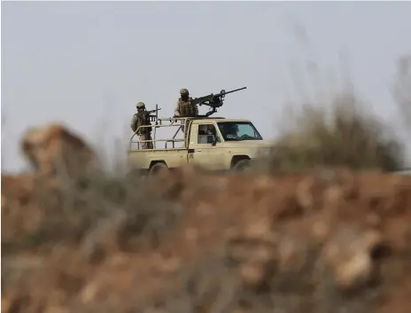  ?? AP ?? Jordanian soldiers go on patrol in Al Washash, an area near the kingdom’s border with Syria