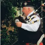  ?? ?? Piper, Ian Turnbull, was among those who played a key role in the remembranc­e ceremony at the Hilton Garden of Remembranc­e.