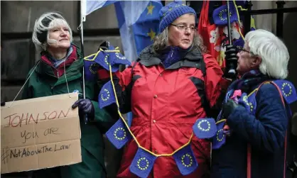  ??  ?? Protesters gather outside the court of session in Edinburgh to hear the result of a legal petition to gain a court order to make Boris Johnson seek a Brexit extension. Photograph: Jeff J Mitchell/Getty Images