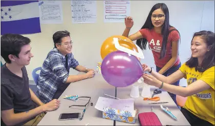  ?? PHOTOS BY LIPO CHING — STAFF PHOTOGRAPH­ER ?? From right, sophomores Serena Spada, Ava Rebollido, Alex Intara and Cameron DeVry make a final inspection of their balloon rocket racer during an engineerin­g class at Summit Shasta charter school in Daly City on Wednesday.