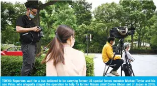  ??  ?? TOKYO: Reporters wait for a bus believed to be carrying former US special forces member Michael Taylor and his son Peter, who allegedly staged the operation to help fly former Nissan chief Carlos Ghosn out of Japan in 2019, arrives at the Tokyo district court in Tokyo on Sunday. —AFP