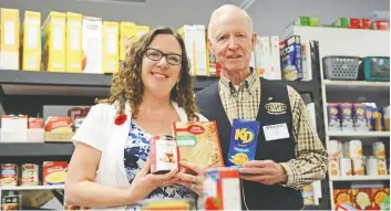  ?? [FAISAL ALI / THE OBSERVER] ?? WCS coordinato­r Tina Reed and Kiwanis member Jim Stewart at the WCS food bank, the shelves of which will be stocked by donations collected during this Saturday’s food drive.