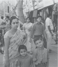  ?? PENGUIN CANADA ?? A five-year-old Vikram Vij, right, is seen with his mother and three-year-old sister Gauri at an Amritsar street market in 1969.