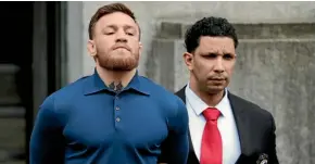  ??  ?? Conor McGregor is escorted to his court appearance in New York.