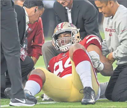  ?? JOSE CARLOS FAJARDO— STAFF PHOTOGRAPH­ER ?? The 49ers’ Solomon Thomas (94) is rolled over after sustaining an apparent head injury during the first quarter of their preseason opener.