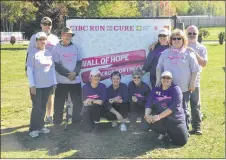  ?? SAM MACDONALD/THE NEWS ?? Volunteers (pink) and directors (purple) with the Canadian Cancer Society CIBC Run for the Cure took time from their work organizing Sunday’s run to pose for a photo in Trenton Park.